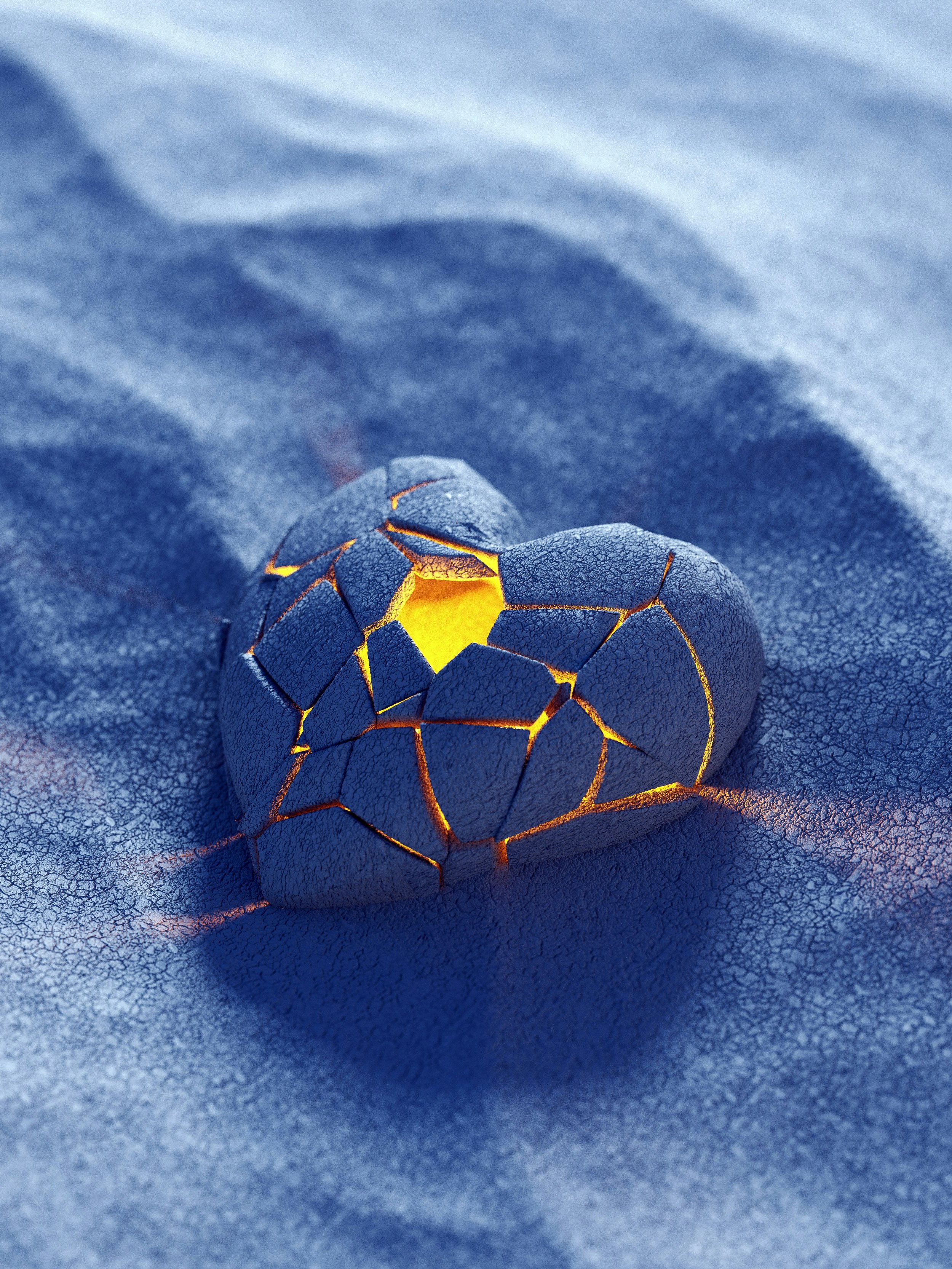 A cracked blue eggshell with glowing yellow light inside resting on a textured blue surface.